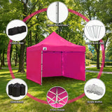 Two people expanding the pink gazebo frame during setup