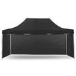 Black pop up gazebo 3 x 4.5 m set up on grass with the roof extended