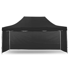 Black pop up gazebo 3 x 4.5 m set up on grass with the roof extended