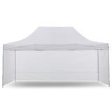 White pop up gazebo 3 x 4.5 m set up on grass with the roof extended