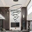 Portofino black six ring LED chandelier suspended over a modern dining table