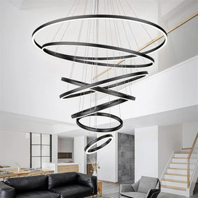 Portofino black seven ring LED chandelier hanging in a contemporary foyer