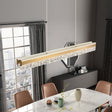 Tellaro gold dual linear pendant above a dining table