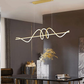 Monterosso gold linear LED pendant at 1.5 metres above a dining table