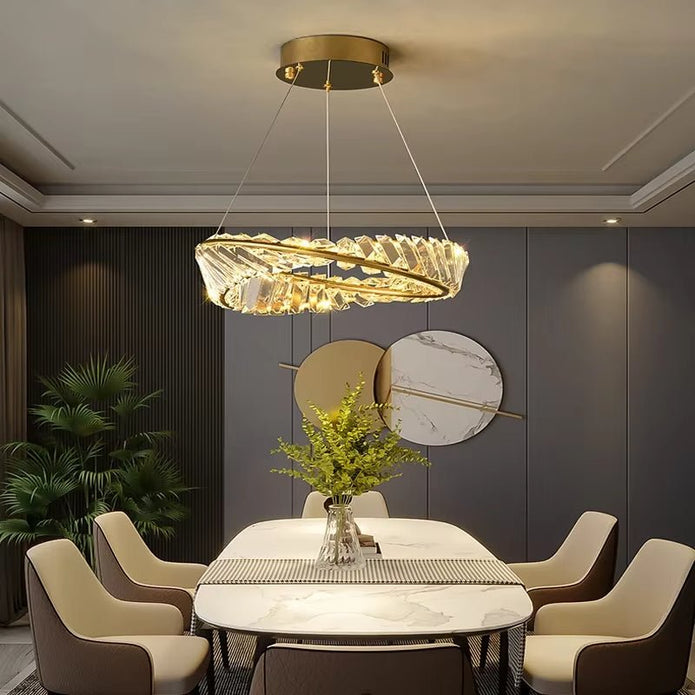 Gold crystal ring chandelier illuminated in a living room