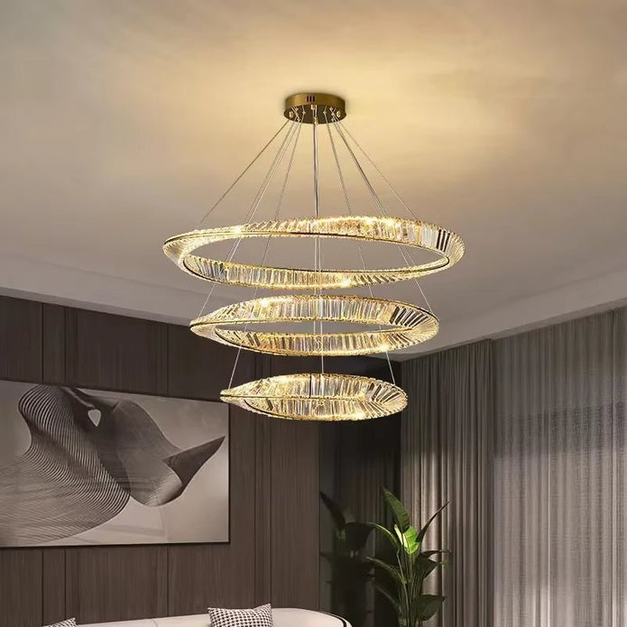 Three tier crystal chandelier illuminated in a living room