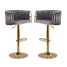 Pair of velvet swivel bar stools with gold round base styled at kitchen island — Allure Home Collections