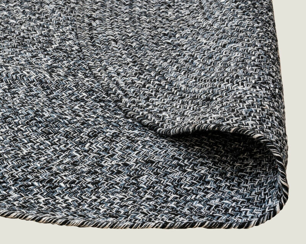 Detail of navy and white braided weave on recycled cotton round rug