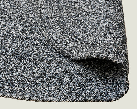 Detail of navy and white braided weave on recycled cotton round rug