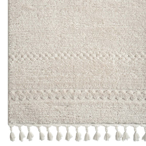 Bukhara ivory plush area rug with sculpted pile and tassels in a serene bedroom