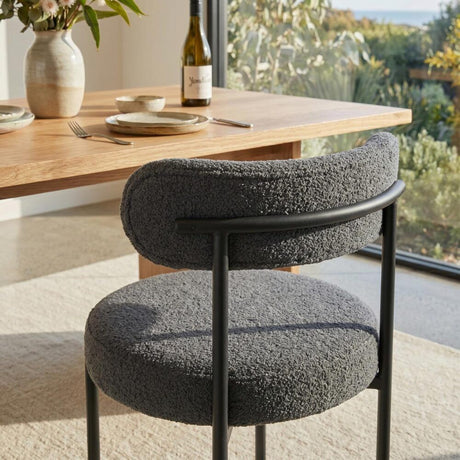 Angaston charcoal boucle dining chair in a modern dining room