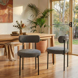 Lobethal slate grey boucle dining chairs with matte black steel legs in a modern dining room