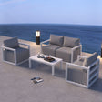 White rattan outdoor lounge set with cushions and glass coffee table