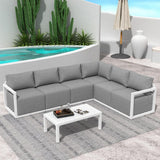 Contemporary white rattan outdoor lounge set with cushions and glass table