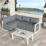 Four seat white rattan outdoor lounge set with cushions and glass table
