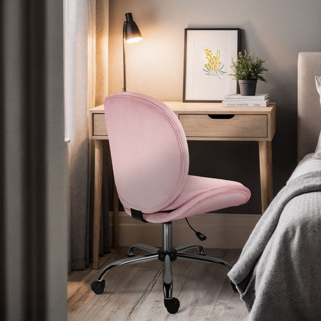 Scarborough pink velvet armless swivel office chair at a desk