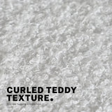 Scarborough white teddy boucle armless swivel office chair at a desk