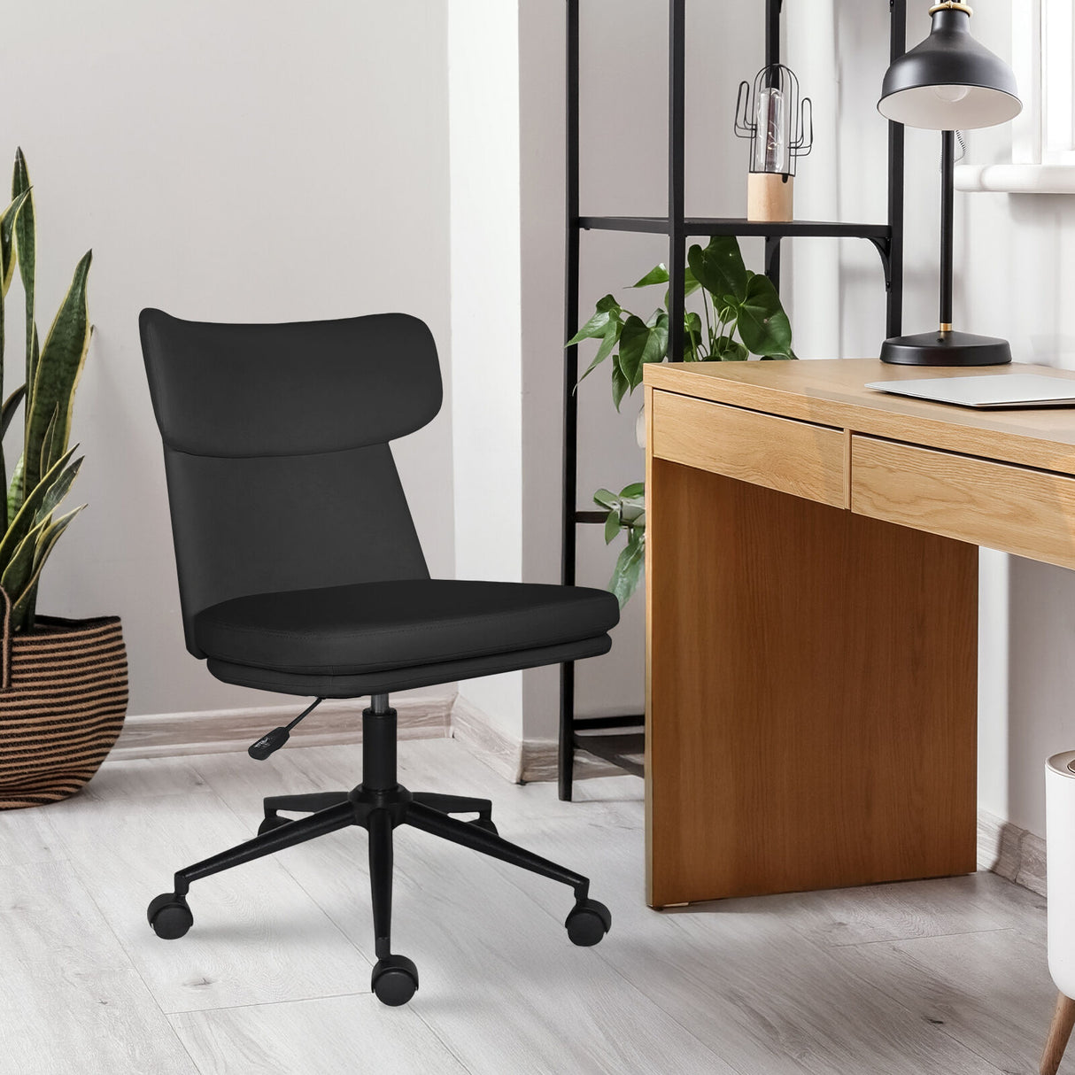 Iluka black faux leather office chair at a desk, view 5