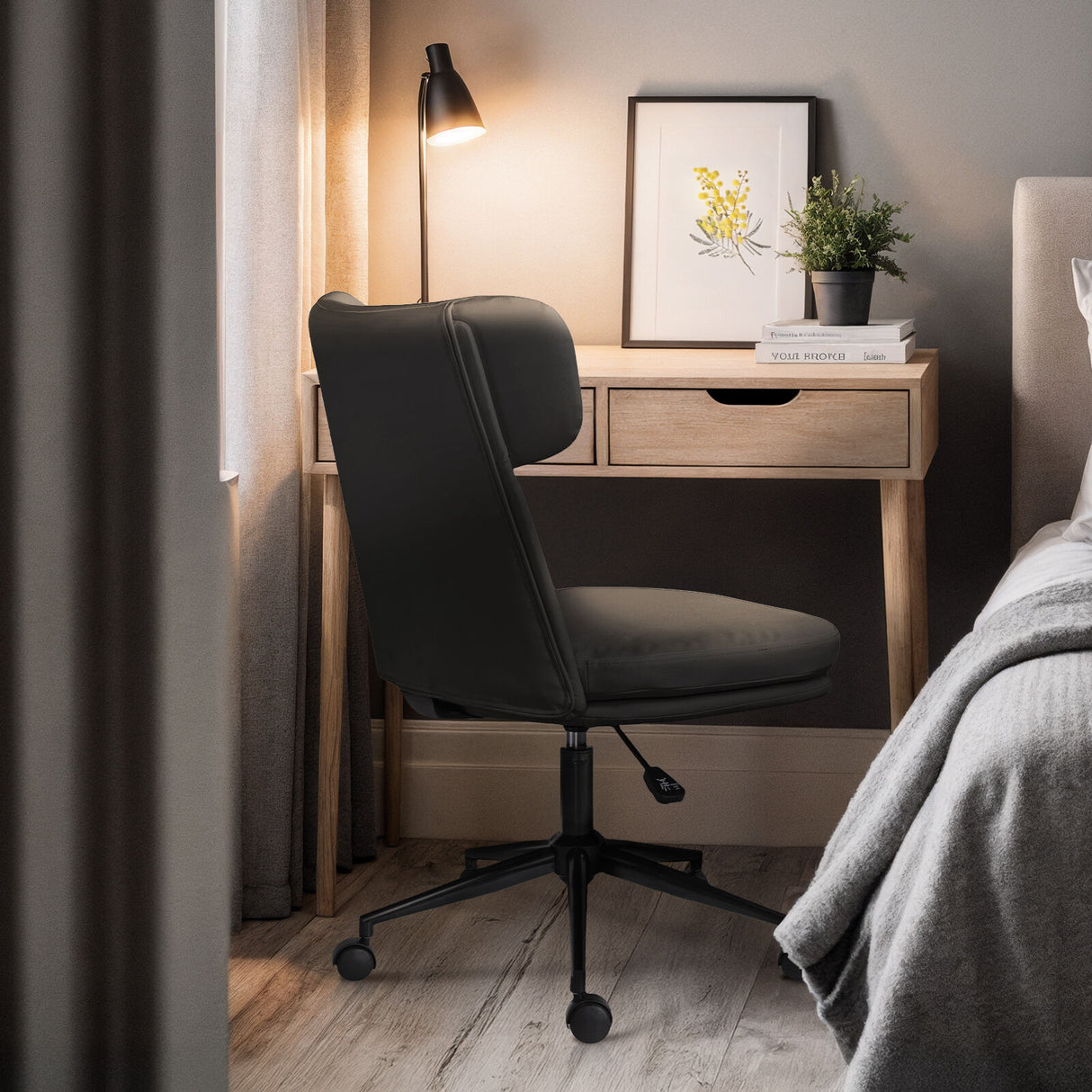 Iluka black faux leather office chair at a desk, view 6