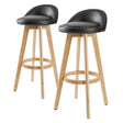Sandhurst black wooden bar stool with PVC leather swivel seat in a Scandinavian kitchen
