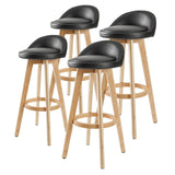 Sandhurst black wooden bar stool with PVC leather swivel seat in a Scandinavian kitchen