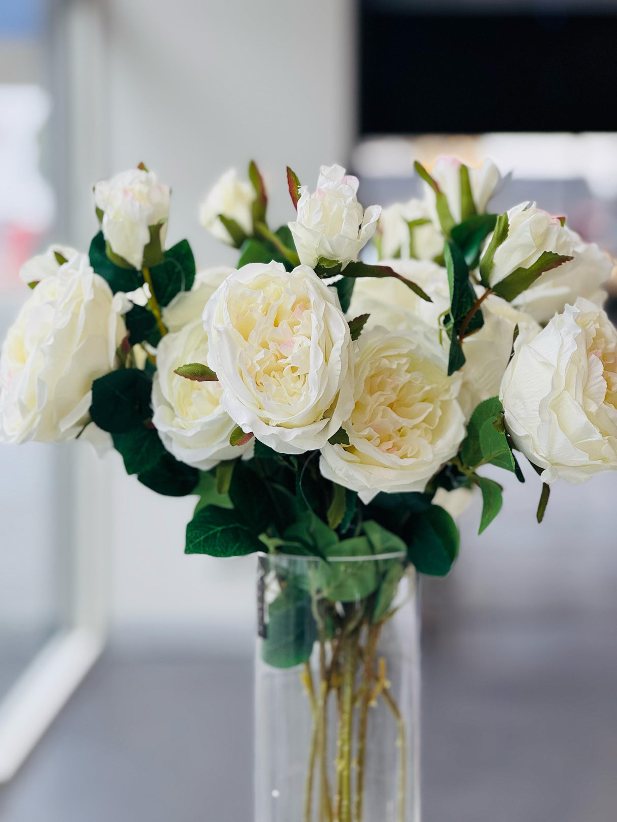 Off-white artificial rose stem close-up showing realistic petal and leaf detail — Allure Home Collections
