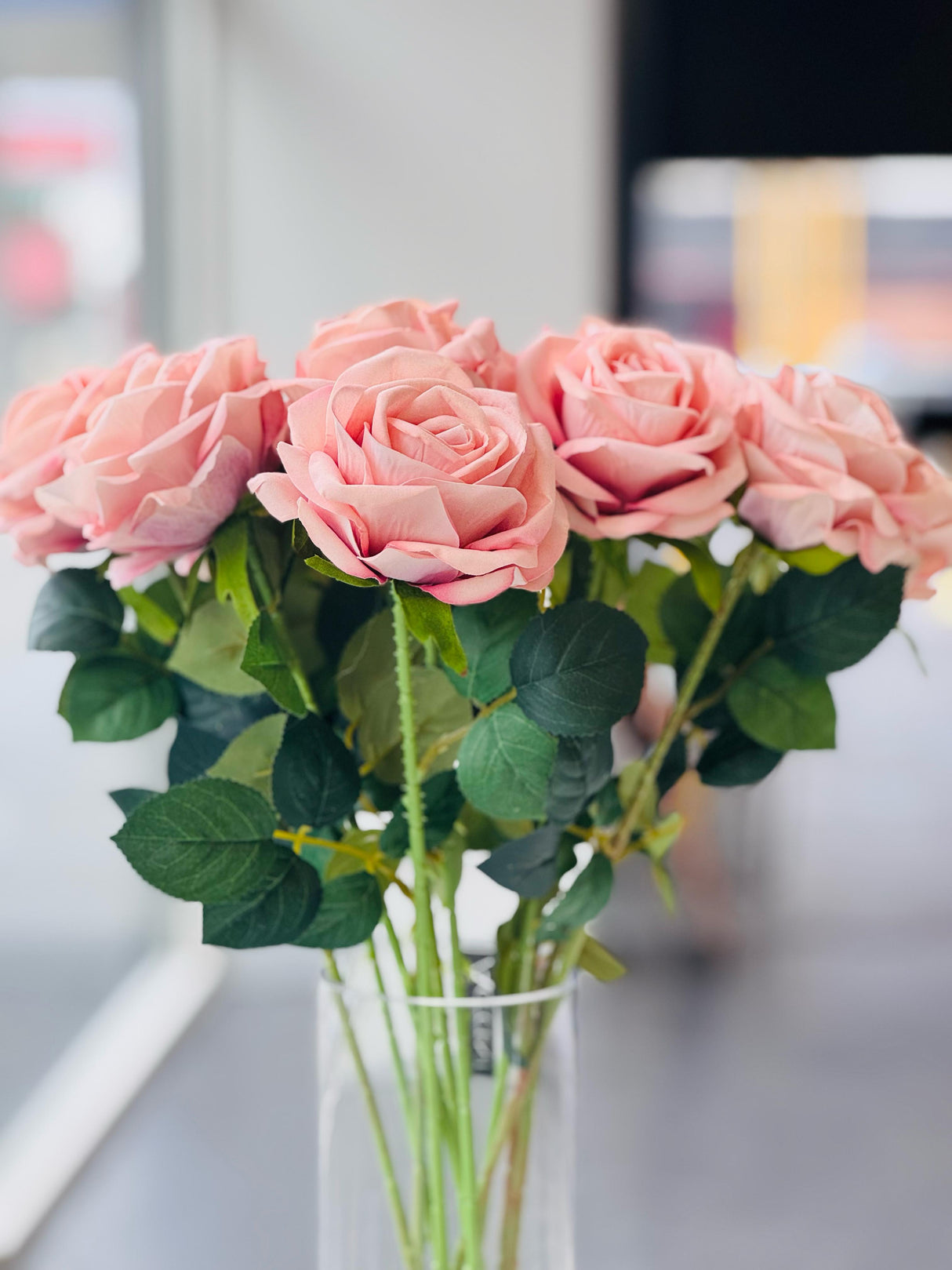 Soft pink artificial rose stem close-up showing lifelike petal and leaf detail — Allure Home Collections