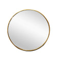 Fairhaven gold round metal wall mirror in a contemporary living room