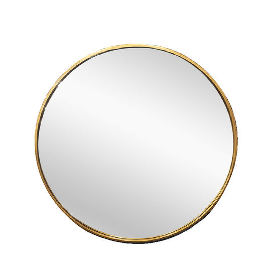 Fairhaven gold round metal wall mirror in a contemporary living room
