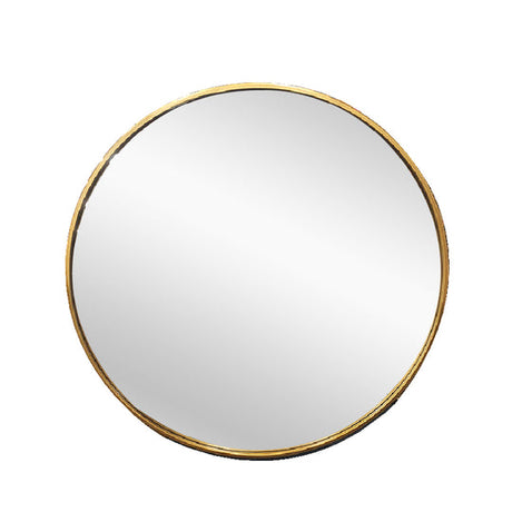 Fairhaven gold round metal wall mirror in a contemporary living room