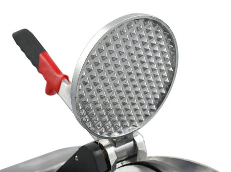 Ice shaver in use producing fluffy shaved ice for snow cones