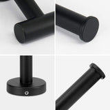 Toilet roll sliding onto the open arm of the black roll holder