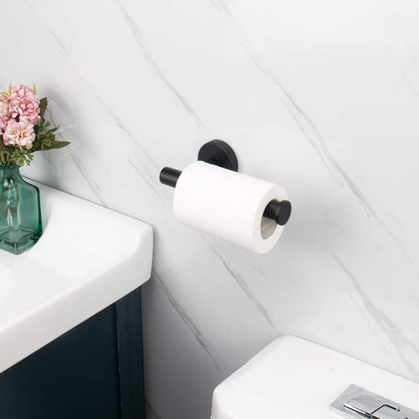 Black roll holder mounted vertically beside a toilet