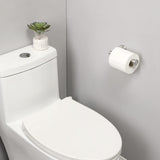 Toilet roll sliding onto the open arm of the brushed silver holder