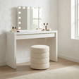 Barwon Heads white boucle ottoman footstool with a sculptural profile in a modern living room