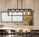 Black industrial chandelier lit with warm white bulbs