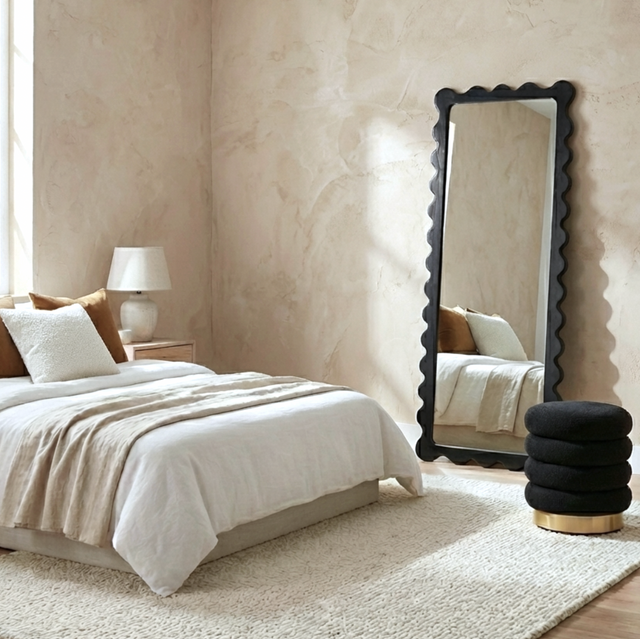 Kennett black scalloped full length floor mirror in an elegant dressing room
