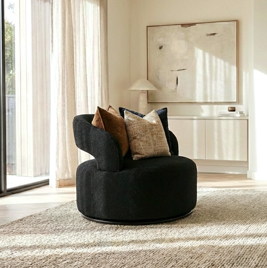 Empress black Milan fabric swivel armchair in a modern living room