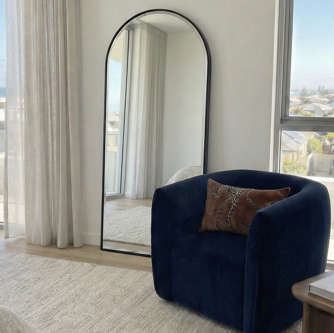 Anglesea black arched floor length mirror leaning in a modern bedroom