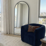 Anglesea black arched floor length mirror leaning in a modern bedroom