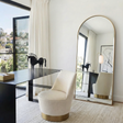 Anglesea gold arched floor length mirror leaning in a modern bedroom