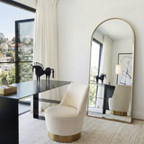 Anglesea gold arched floor length mirror leaning in a modern bedroom