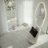 Lorne irregular backlit LED wall mirror in a styled bedroom