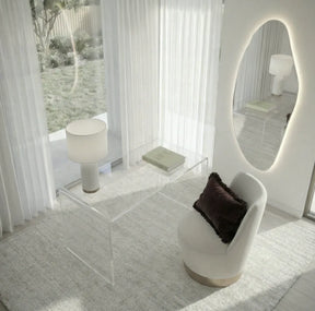Lorne irregular backlit LED wall mirror in a styled bedroom