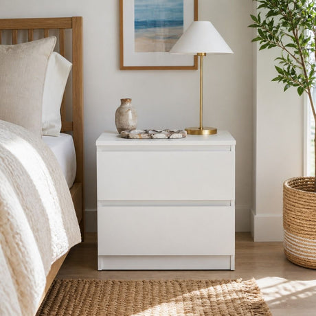 Nimbin warm white two drawer bedside table with finger pull drawers in a compact bedroom