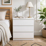Nimbin warm white three drawer bedside table with finger pull drawers in a minimalist bedroom