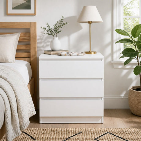 Nimbin warm white three drawer bedside table with finger pull drawers in a minimalist bedroom