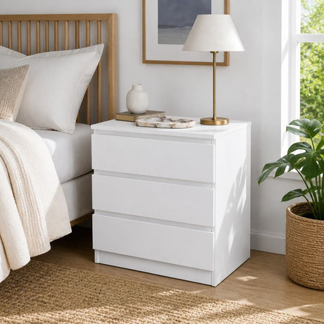 Nimbin warm white three drawer bedside table with finger pull drawers in a minimalist bedroom