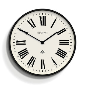 Sebastian matt black wall clock with Roman numerals on a living room wall
