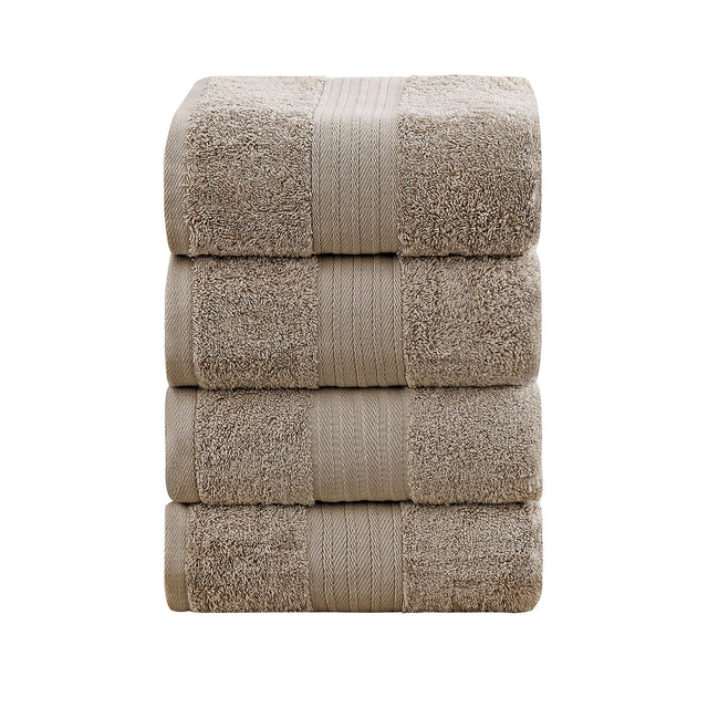 Set of four sandstone 550 GSM ring spun cotton bath towels folded and stacked